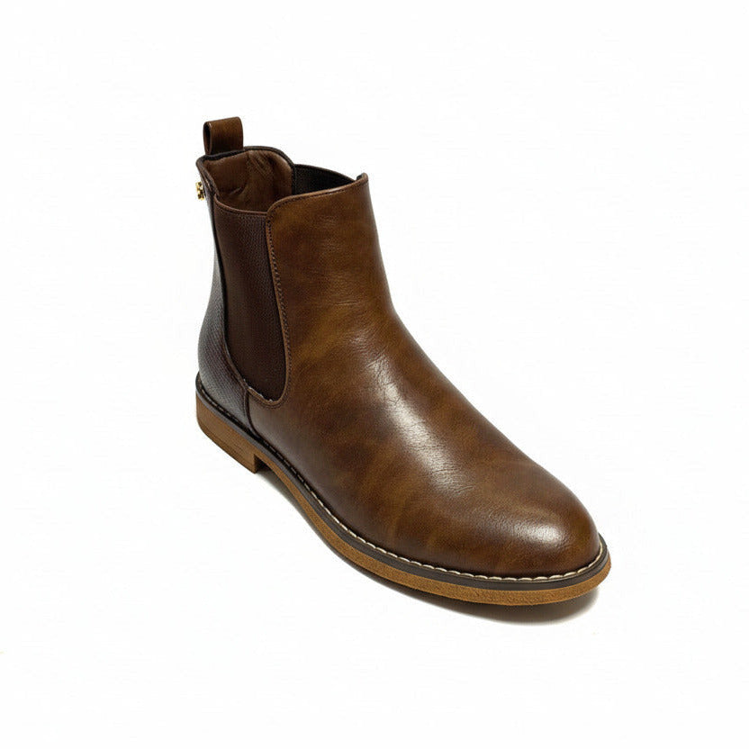 Butterfly Celeste 4 Chocolate Ankle Boot, a stylish faux leather slip-on boot with a round toe, elastic gusset, and contrast back heel detail. Features a comfort sock for all-day wear and a 2.5 cm heel. Perfect for casual and chic styling. 2