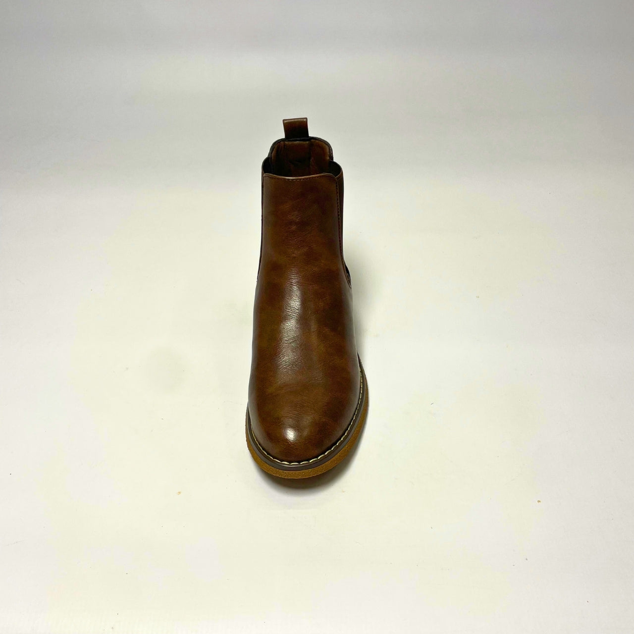 Butterfly Celeste 4 Chocolate Ankle Boot, a stylish faux leather slip-on boot with a round toe, elastic gusset, and contrast back heel detail. Features a comfort sock for all-day wear and a 2.5 cm heel. Perfect for casual and chic styling. 4