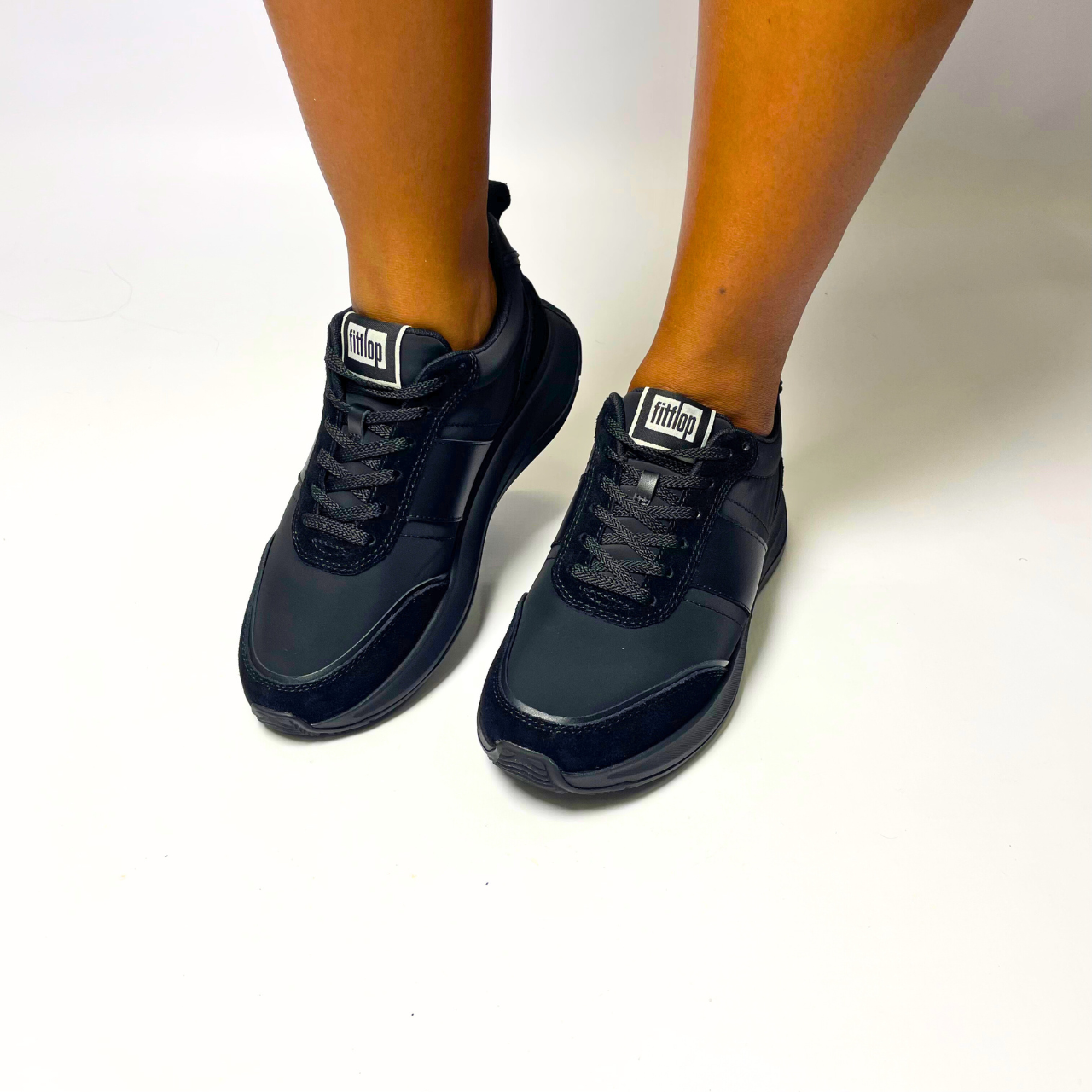 FitFlop F-Mode Flow Fabric Flatform black sneaker with cushioned Microwobbleboard midsole, arch support & recycled PET fabric upper. 1