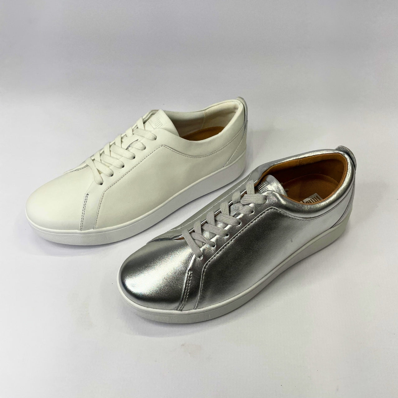 FitFlop Rally leather silver and white sneaker with flexible cushioning, anatomically contoured footbed & slip-resistant rubber pods for comfort and support.