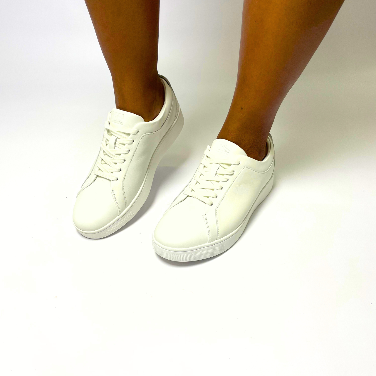 FitFlop Rally leather urban white sneaker with ultra-flexible cushioning, anatomically contoured footbed & slip-resistant rubber pods for maximum comfort. 1
