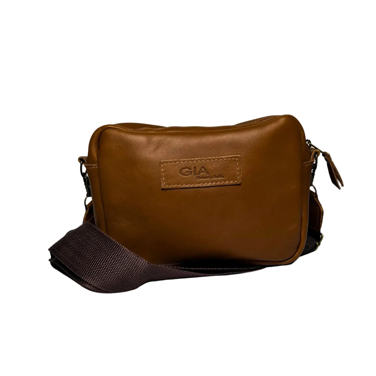 Gia Camera Bag in Texas Toffee leather – compact crossbody with zip closure, rear magnetic pocket, adjustable strap, and embossed GIA logo patch 1