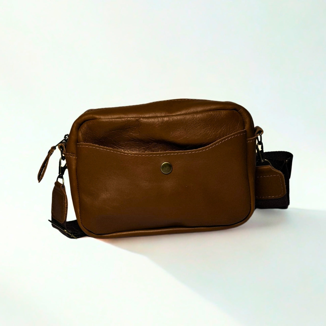 Gia Camera Bag in Texas Toffee leather β compact crossbody with zip closure, rear magnetic pocket, adjustable strap, and embossed GIA logo patch 2