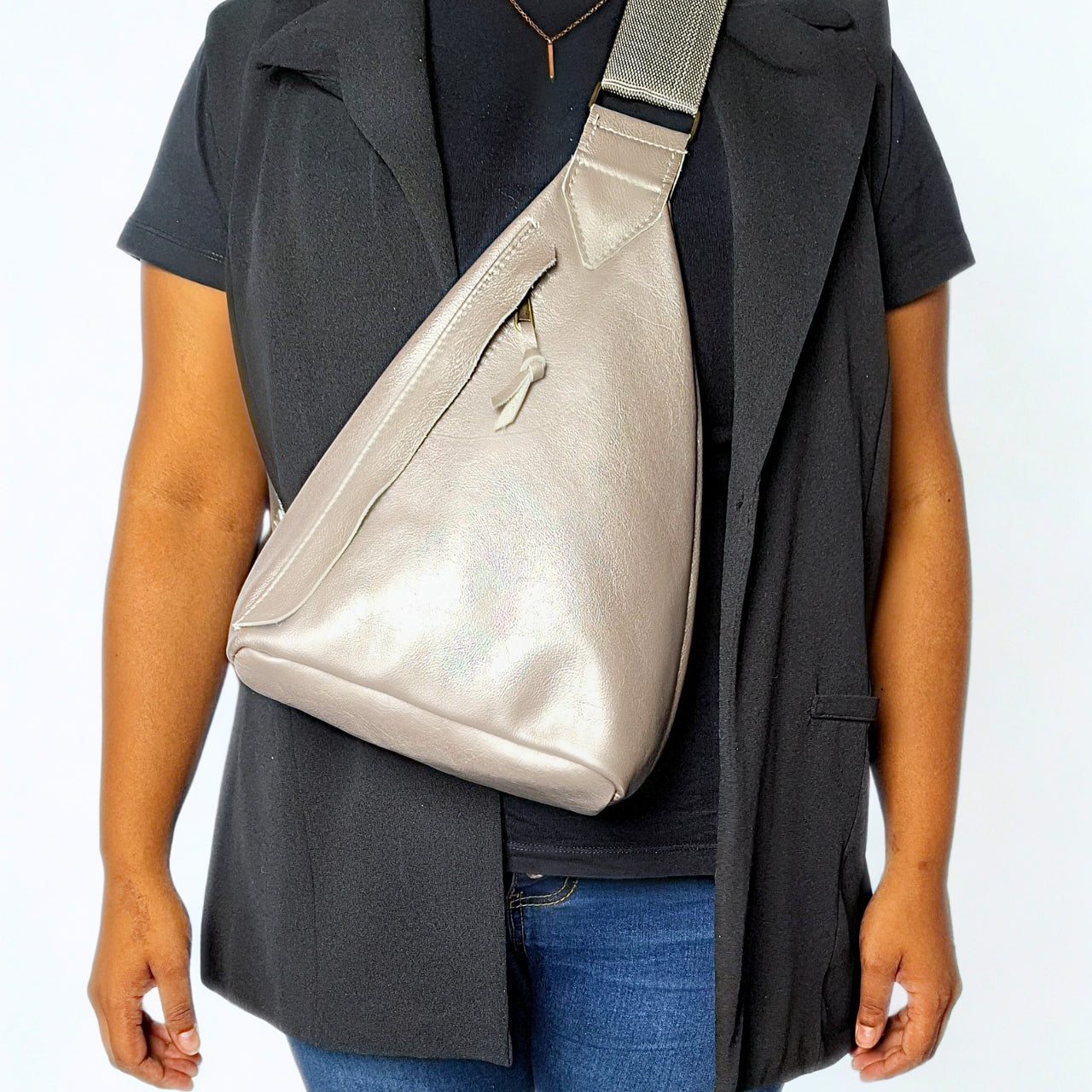 Gia Triangle Backpack in metallic pewter leather – modern triangular silhouette with gold-tone buckle, front and rear zip pockets, and embossed leather logo patch. 3