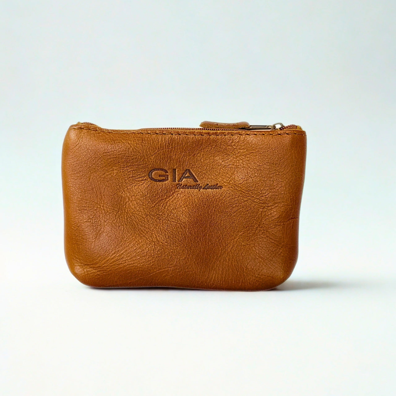 Gia Tan Double Zip Lipstick Purse, crafted from genuine leather. Features two secure zippered compartments for easy organization, perfect for lipstick, coins, and small essentials.
1