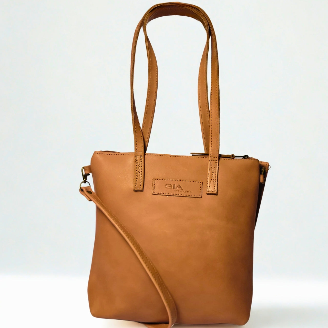 Gia toffee leather dual tote with zip closure, shoulder straps, and crossbody option. 1