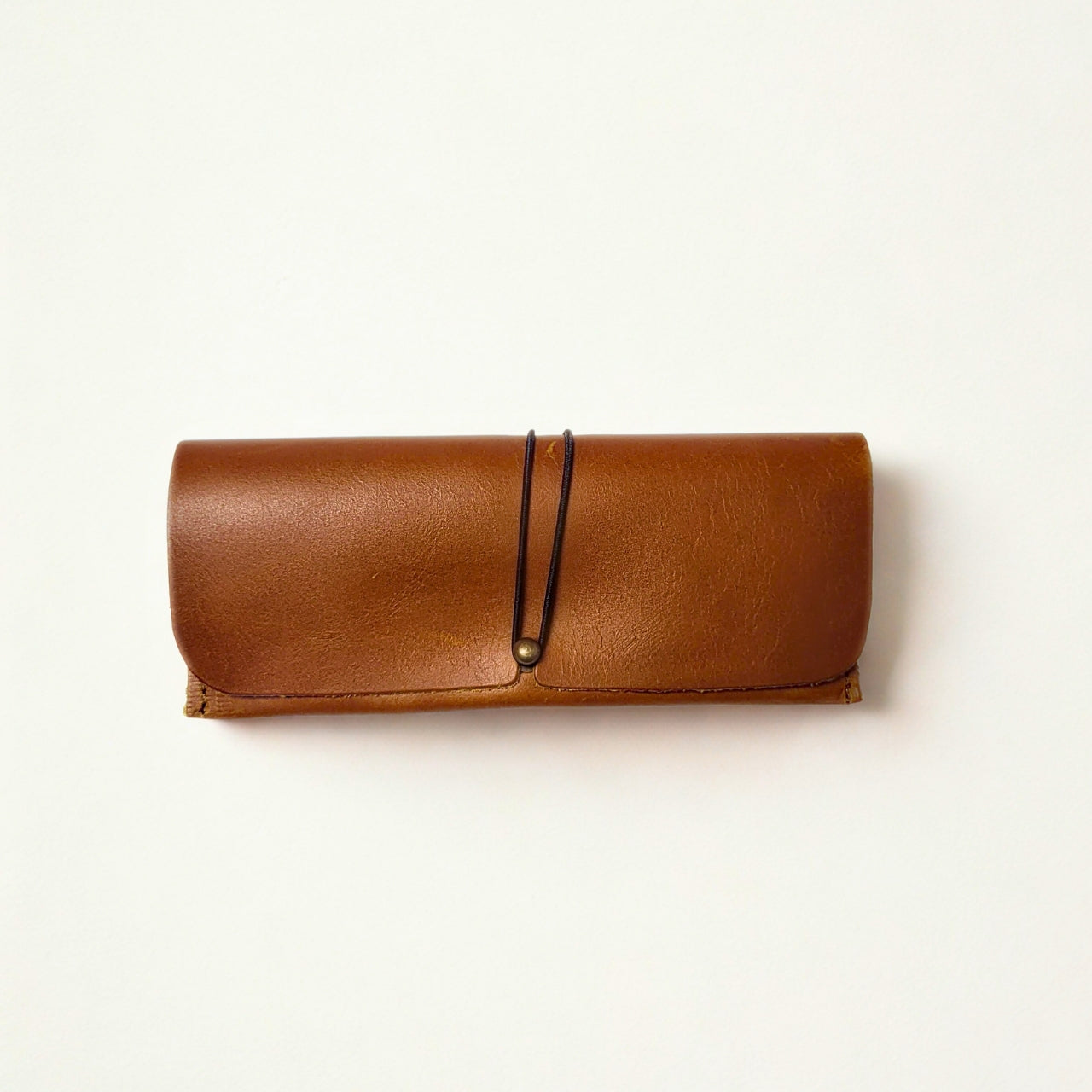 Gia toffee leather sunglass case with snap closure and soft lining for scratch protection. 2
