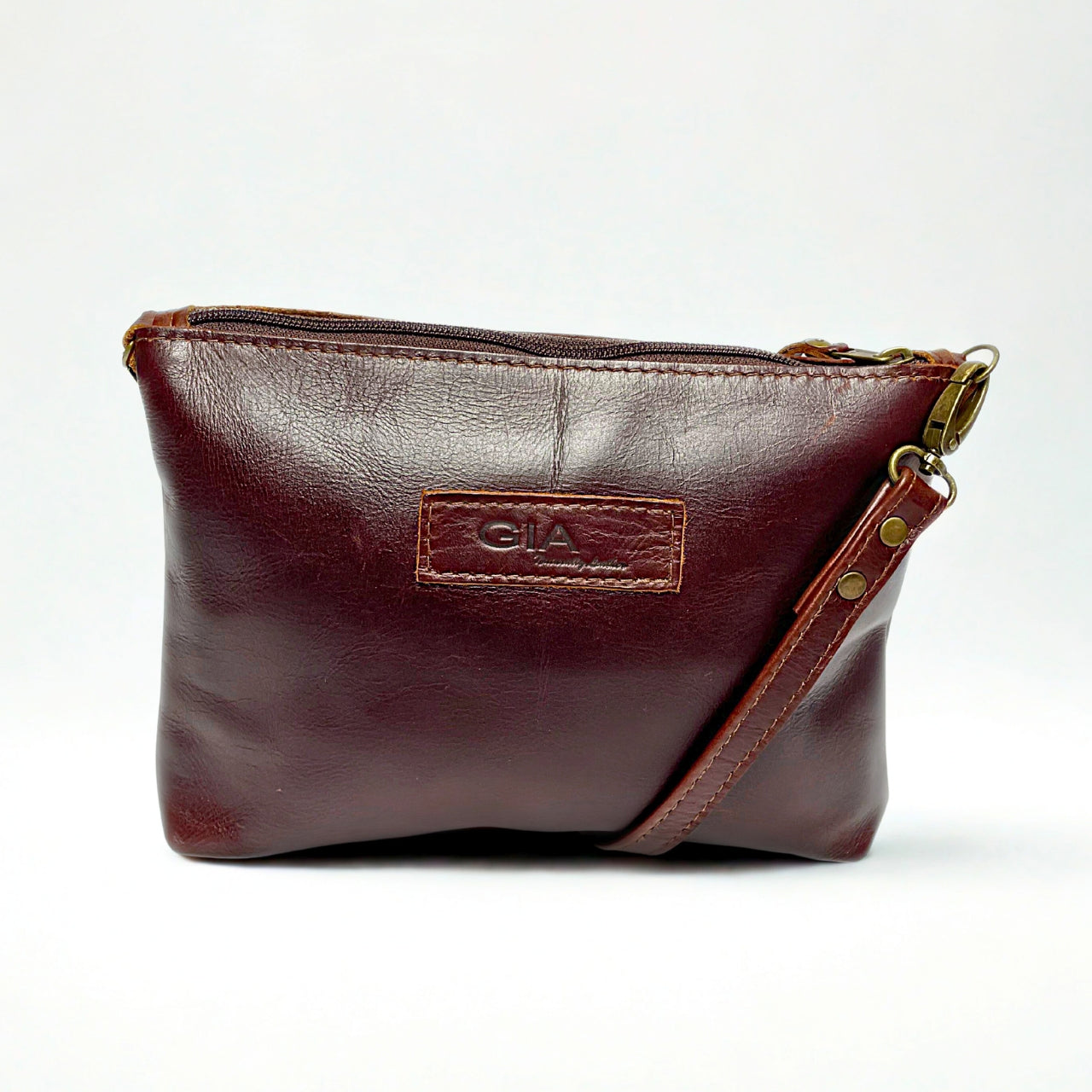 Gia dark brown leather crossbody bag with adjustable strap and compact everyday design.