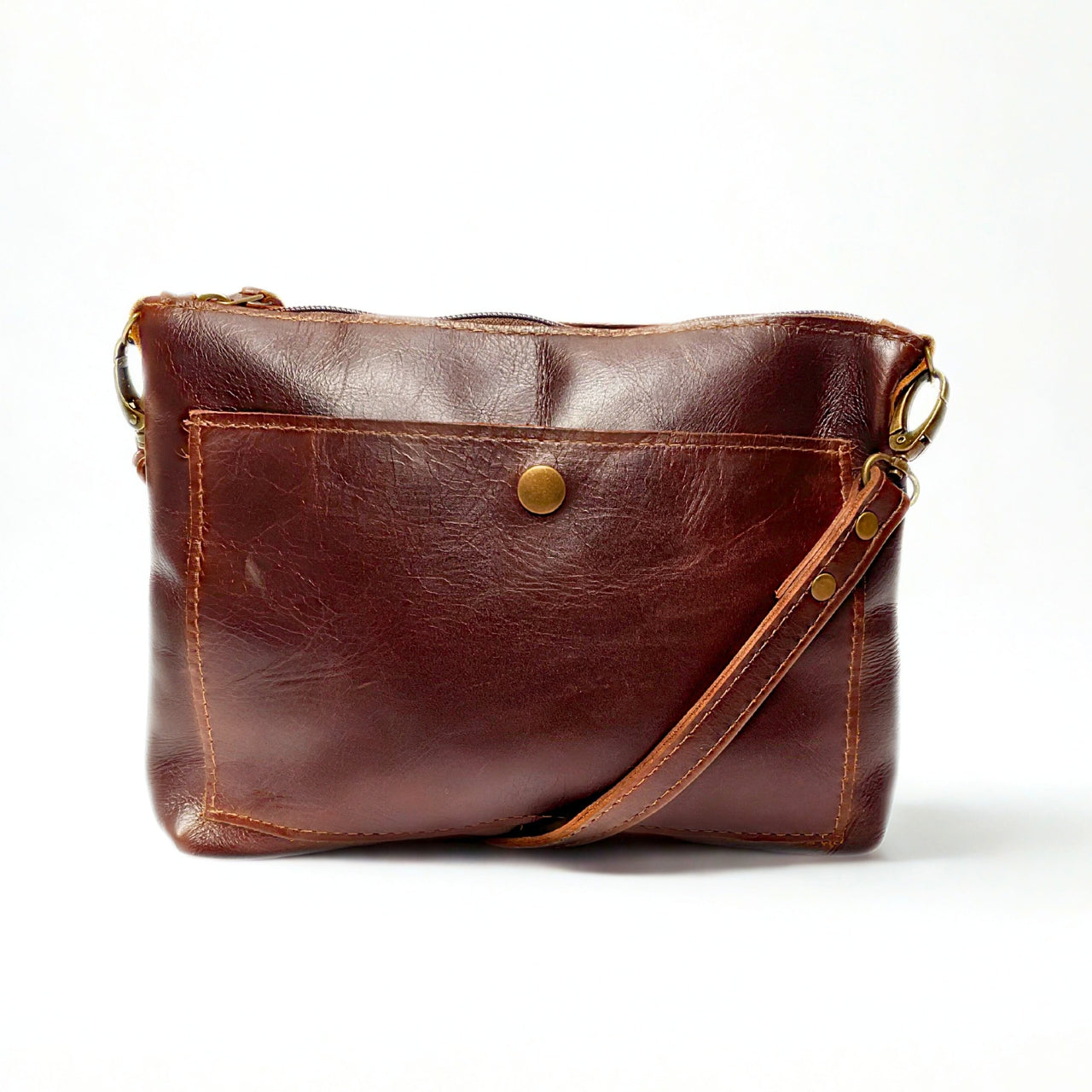 Gia dark brown leather crossbody bag with adjustable strap and compact everyday design.