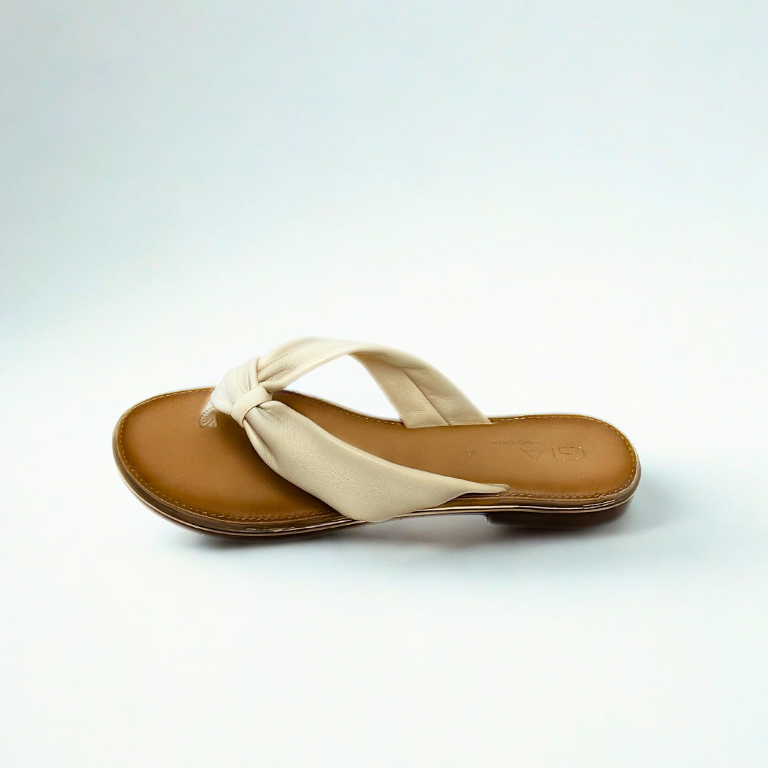 Gia beige leather knot sandals with cushioned insole, slip-on design, and knotted strap detail – chic women’s summer footwear for casual wear, holidays, and resort style.
