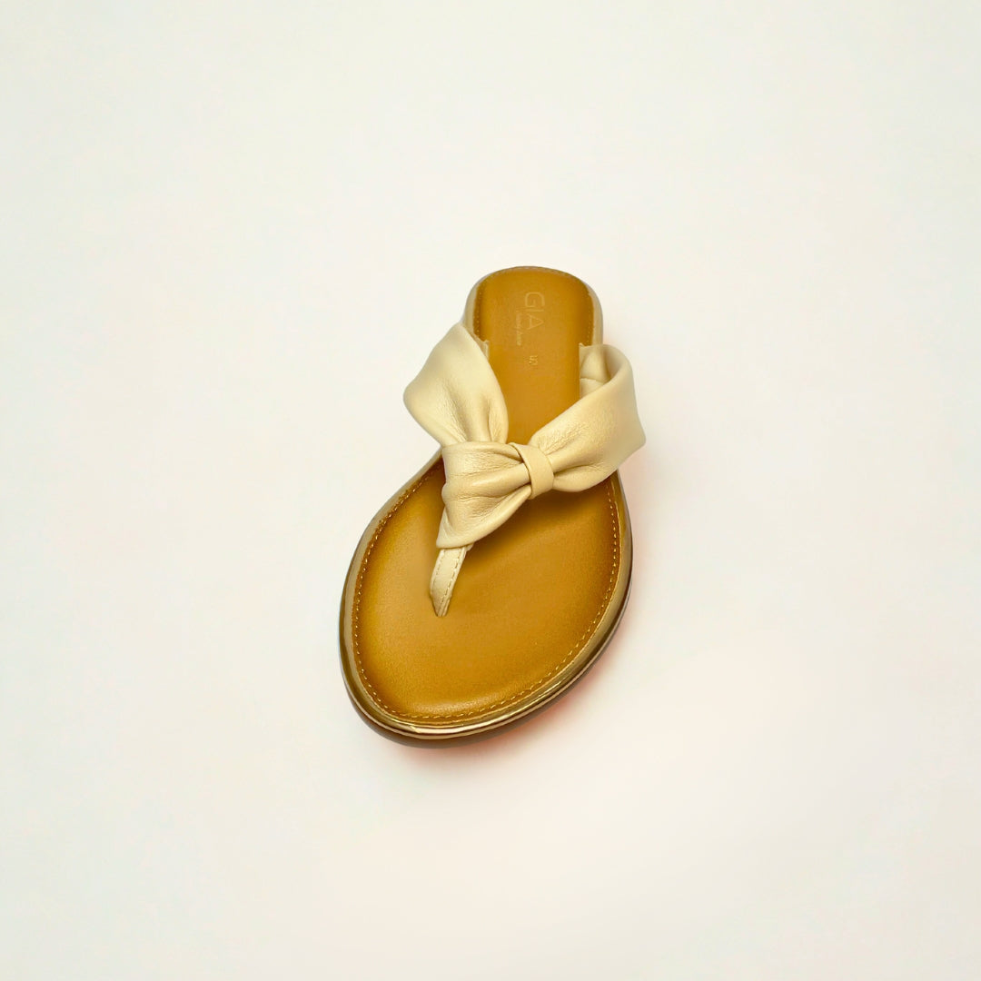 Gia beige leather knot sandals with cushioned insole, slip-on design, and knotted strap detail – chic women’s summer footwear for casual wear, holidays, and resort style.