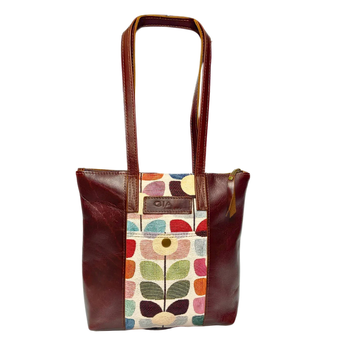 Gia dark brown leather tote with vibrant tulip fabric panel, front zip pocket, and dual handles.
