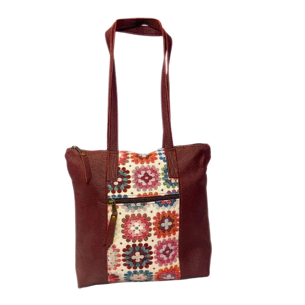 Gia dark red leather tote bag with woven tapestry panel, dual shoulder straps, antique brass hardware, and embossed logo â spacious crochet-inspired handbag for work, travel, and everyday wear.