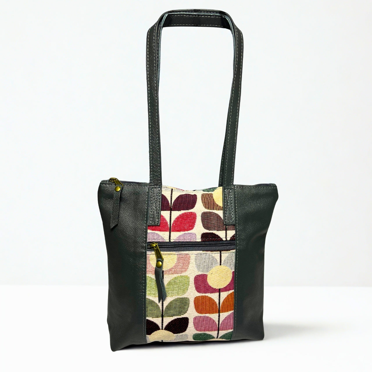 Gia grey leather tote with tulip fabric front panel, zip pocket, and dual shoulder handles.