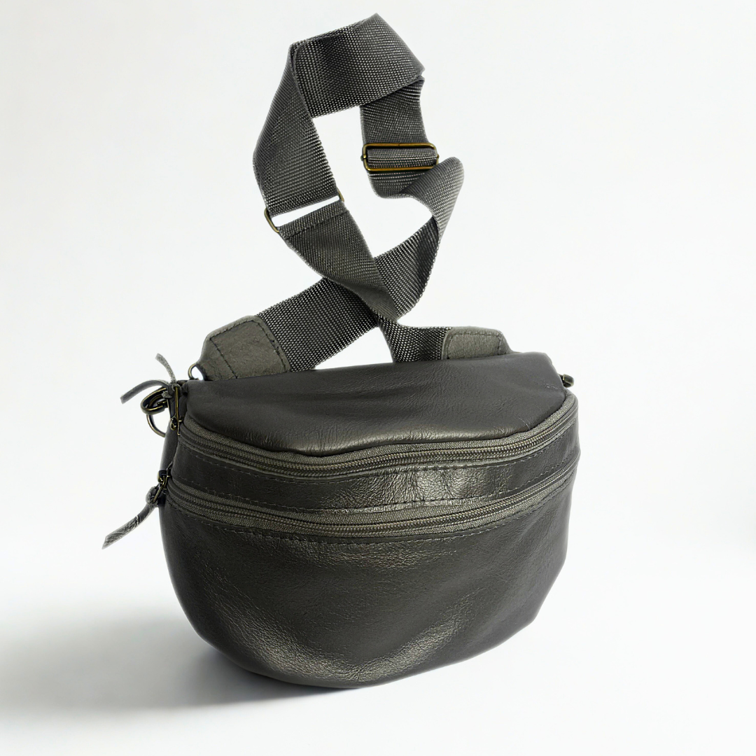Gia pewter leather moon bag with wide adjustable strap, metallic finish, antique brass hardware, and embossed logo – versatile crossbody or waist bag for modern street style and everyday use.