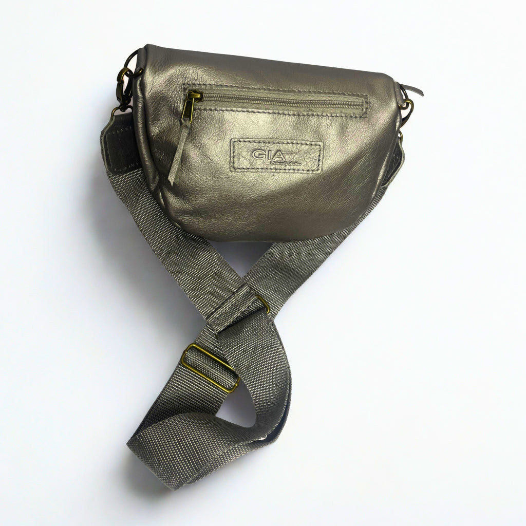 Gia pewter leather moon bag with wide adjustable strap, metallic finish, antique brass hardware, and embossed logo – versatile crossbody or waist bag for modern street style and everyday use.