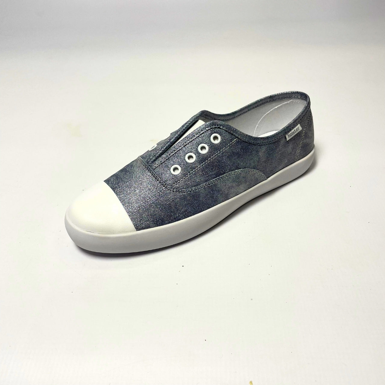 Holster Lulu Denim Shimmer Sneaker β Vegan-friendly, cruelty-free slip-on sneaker with a metallic PU upper and white PU toe cap. Features elastic gusset for easy wear, eyelet embellishments, and a soft PU foam insole for comfort. Designed with a non-slip rubber outsole and antibacterial properties. 2