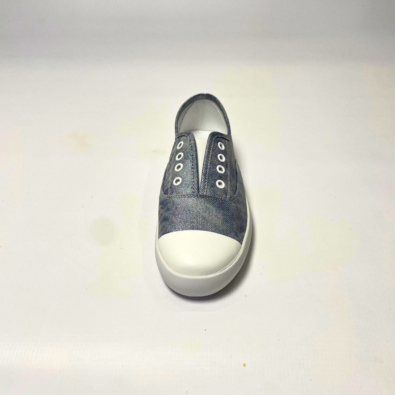 Holster Lulu Denim Shimmer Sneaker β Vegan-friendly, cruelty-free slip-on sneaker with a metallic PU upper and white PU toe cap. Features elastic gusset for easy wear, eyelet embellishments, and a soft PU foam insole for comfort. Designed with a non-slip rubber outsole and antibacterial properties. 4