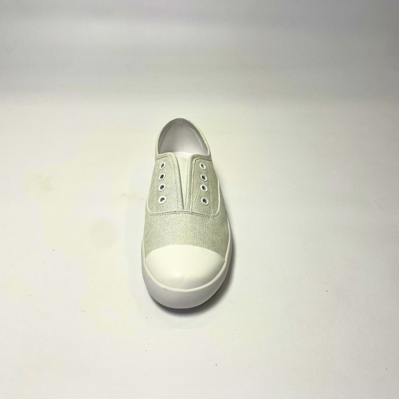Holster Lulu Pearl Shimmer Sneaker – Vegan-friendly, cruelty-free slip-on sneaker with a metallic PU upper and white PU toe cap. Features elastic gusset for easy wear, eyelet embellishments, and a soft PU foam insole for comfort. Designed with a non-slip rubber outsole and antibacterial properties. 4