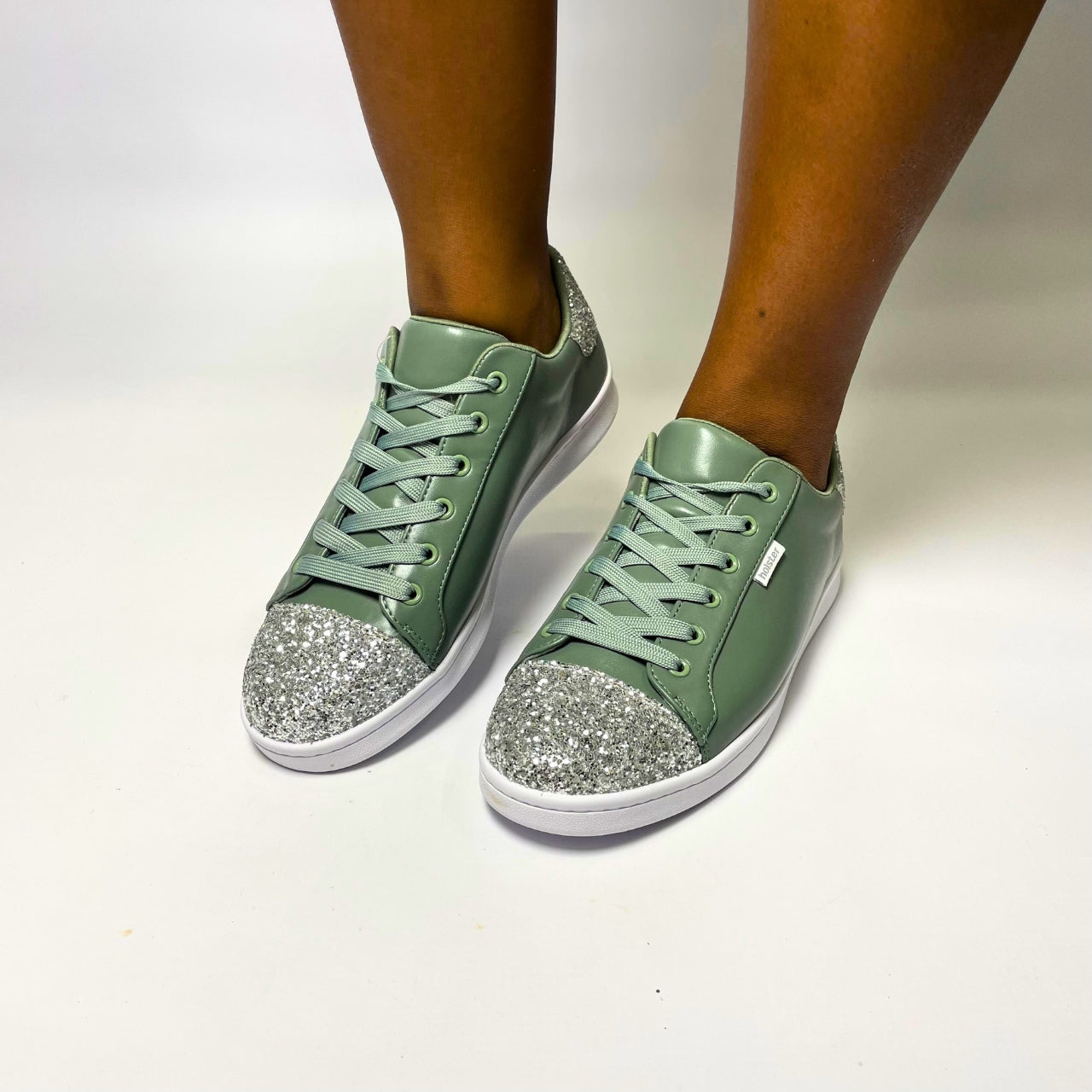 Holster Stardust Green Sneaker – Vegan-friendly, PETA-approved sneaker featuring a glitter toe and heel cap. Designed with a soft padded PU upper, cushioned PU foam insole, and non-slip rubber outsole for comfort and durability. Lightweight, antibacterial, and flexible. Adjustable polyester shoelaces for a secure fit. 1