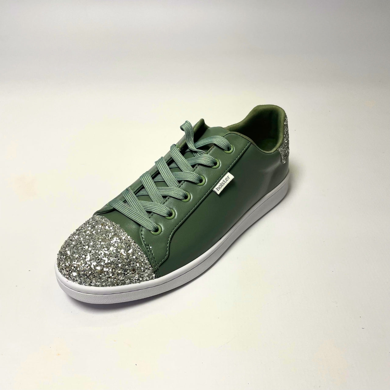 Holster Stardust Green Sneaker – Vegan-friendly, PETA-approved sneaker featuring a glitter toe and heel cap. Designed with a soft padded PU upper, cushioned PU foam insole, and non-slip rubber outsole for comfort and durability. Lightweight, antibacterial, and flexible. Adjustable polyester shoelaces for a secure fit. 2