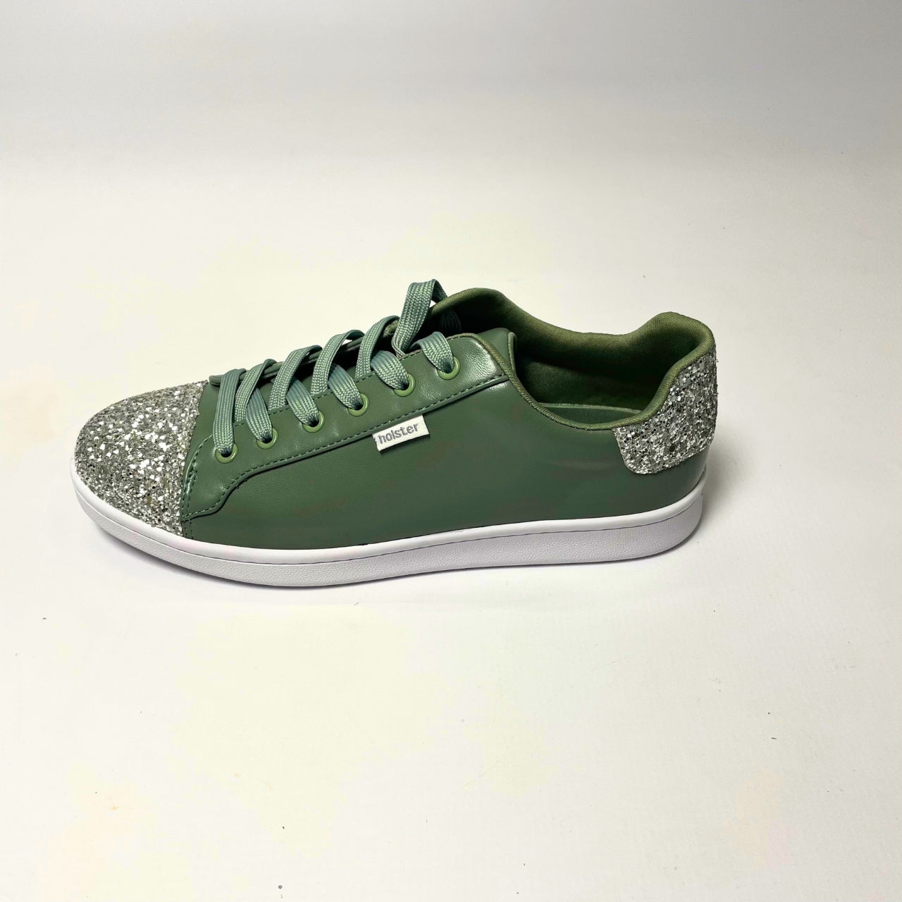 Holster Stardust Green Sneaker – Vegan-friendly, PETA-approved sneaker featuring a glitter toe and heel cap. Designed with a soft padded PU upper, cushioned PU foam insole, and non-slip rubber outsole for comfort and durability. Lightweight, antibacterial, and flexible. Adjustable polyester shoelaces for a secure fit. 3
