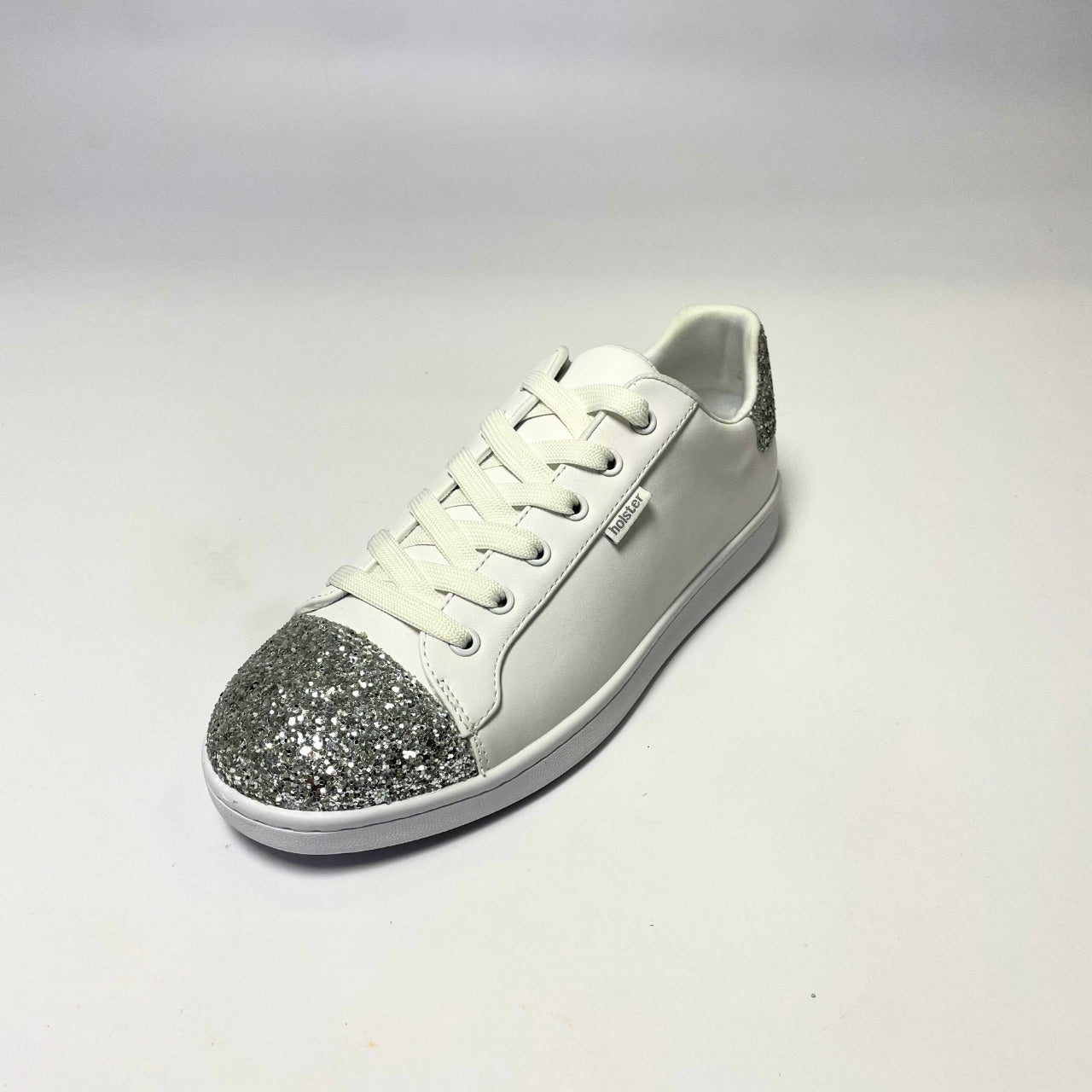 Holster Stardust White Sneaker – Vegan-friendly, PETA-approved sneaker featuring a glitter toe and heel cap. Designed with a soft padded PU upper, cushioned PU foam insole, and non-slip rubber outsole for comfort and durability. Lightweight, antibacterial, and flexible. Adjustable polyester shoelaces for a secure fit. 2