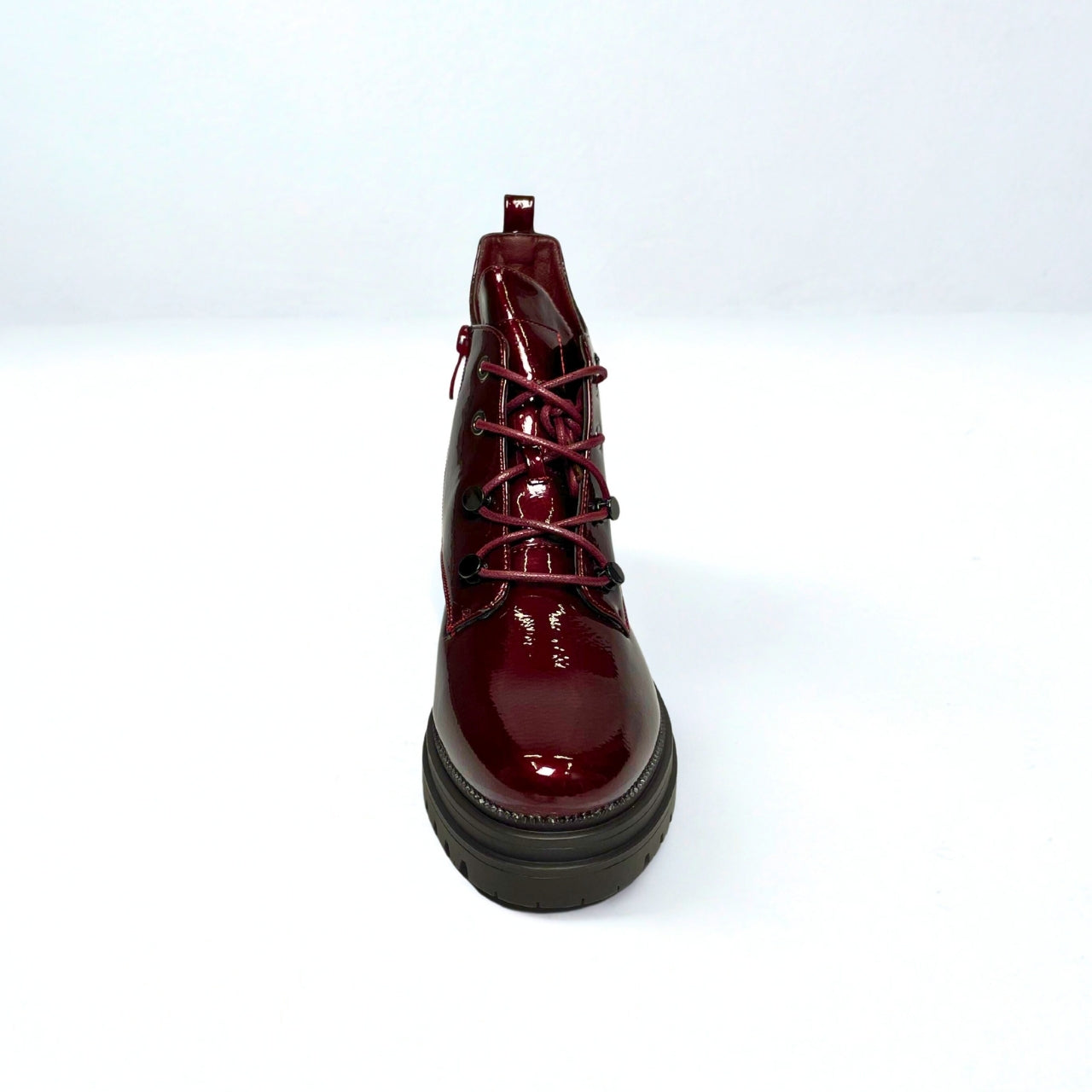 Burgundy faux leather chunky lace-up boots with gold eyelets, side zip, and thick treaded sole for bold street style.