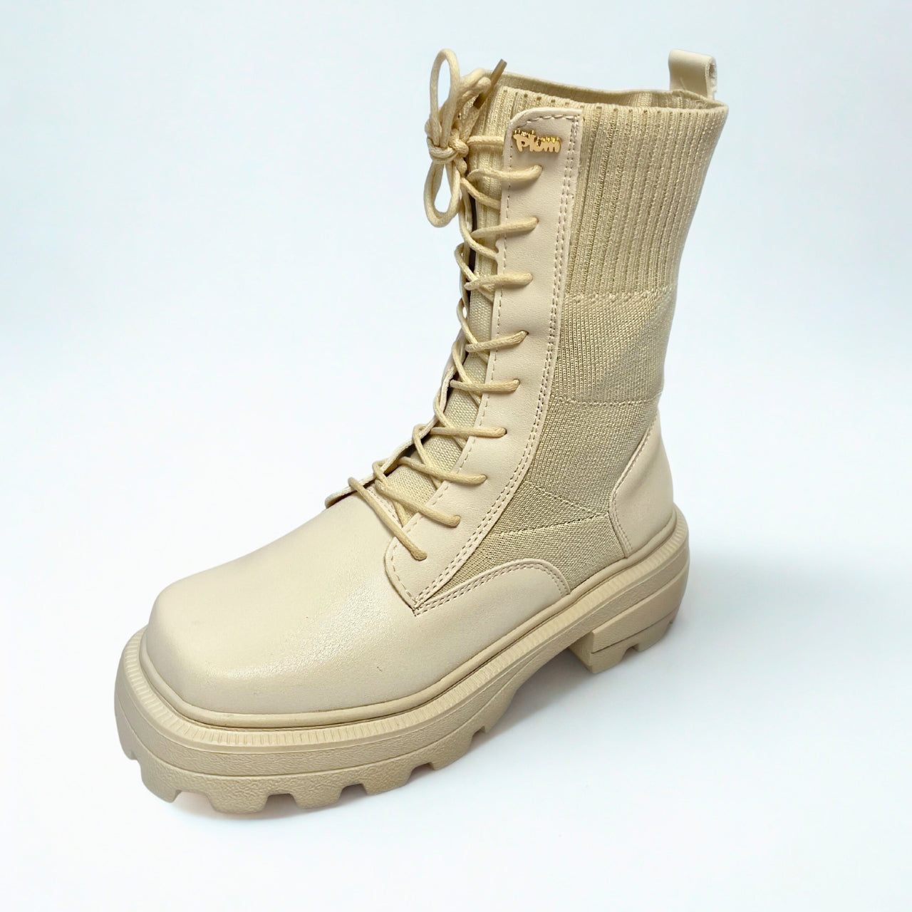 Plum beige combat-style boot with ribbed knit shaft, chunky lug sole, and lace-up front.