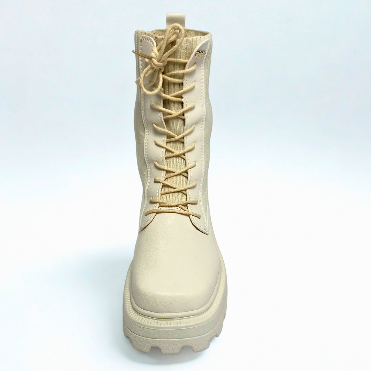 Plum beige combat-style boot with ribbed knit shaft, chunky lug sole, and lace-up front.