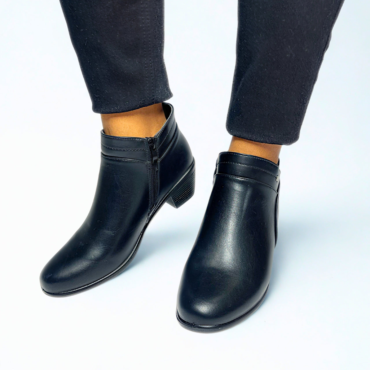 Black ankle boot with low block heel, tapered toe, side zip, and silver stud detail — perfect for smart-casual wear.