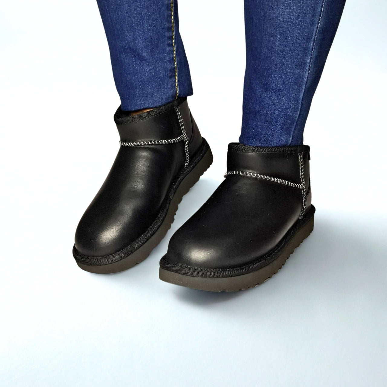 UGG Classic Ultra Mini Leather Regenerate Boot in Black – regenerative leather upper, UGGplush™ lining, sugarcane EVA outsole, and eco-conscious details for casual wear 1