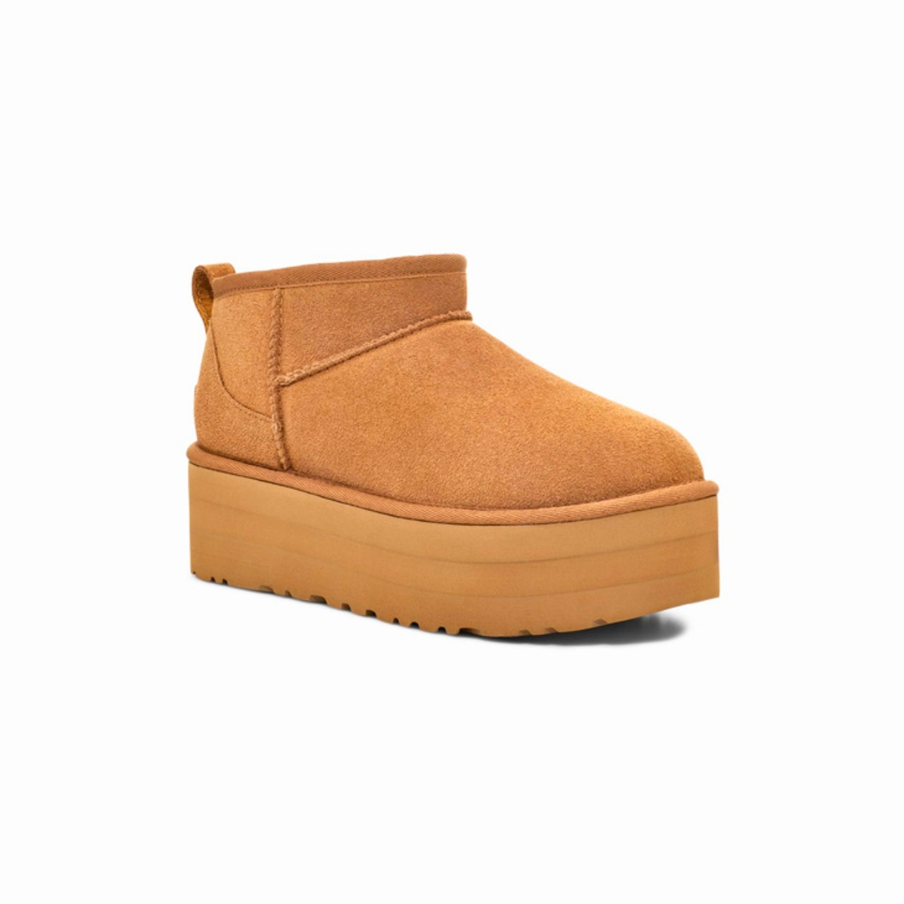 UGG Classic Ultra Mini Platform Boot in Chestnut – A stylish ankle-height boot featuring a suede upper with overlock stitch detailing and a rear pull tab. Designed with a cozy 17mm UGGplush™ lining and insole made from upcycled wool and TENCEL™ Lyocell. Built with a lightweight EVA midsole and a 2" platform Sugarcane EVA or Treadlite outsole for all-day comfort. Finished with an asymmetrical topline, polyester binding, and embossed UGG® logo on the suede heel. Shaft height: 3.5 inches. 2