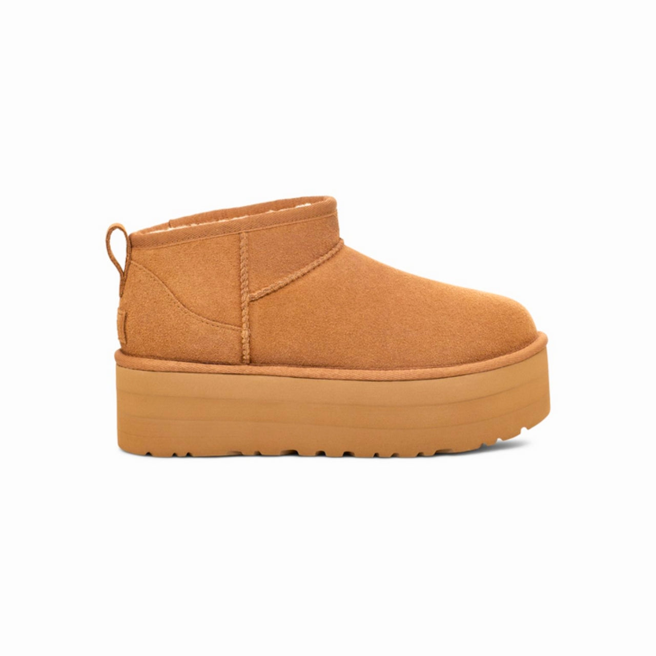 UGG Classic Ultra Mini Platform Boot in Chestnut – A stylish ankle-height boot featuring a suede upper with overlock stitch detailing and a rear pull tab. Designed with a cozy 17mm UGGplush™ lining and insole made from upcycled wool and TENCEL™ Lyocell. Built with a lightweight EVA midsole and a 2" platform Sugarcane EVA or Treadlite outsole for all-day comfort. Finished with an asymmetrical topline, polyester binding, and embossed UGG® logo on the suede heel. Shaft height: 3.5 inches. 3