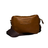 Gia Camera Bag in Texas Toffee leather – compact crossbody with zip closure, rear magnetic pocket, adjustable strap, and embossed GIA logo patch 1