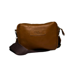 Gia Camera Bag in Texas Toffee leather – compact crossbody with zip closure, rear magnetic pocket, adjustable strap, and embossed GIA logo patch 1