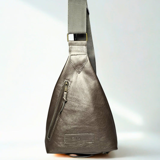 Gia Triangle Backpack in metallic pewter leather – modern triangular silhouette with gold-tone buckle, front and rear zip pockets, and embossed leather logo patch 1