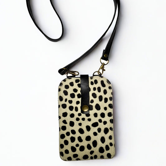 Gia Cell Bag in black and white cheetah print – hair-on-hide leather, compact hands-free design with gold hardware and detachable strap, fits most smartphones. 1