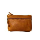 Gia Tan Double Zip Lipstick Purse, crafted from genuine leather. Features two secure zippered compartments for easy organization, perfect for lipstick, coins, and small essentials. 
2