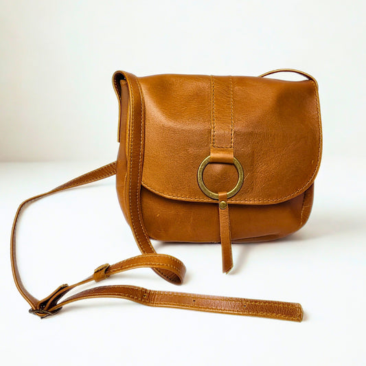  Gia tan leather saddle crossbody bag with brass ring detail and flap closure. 1