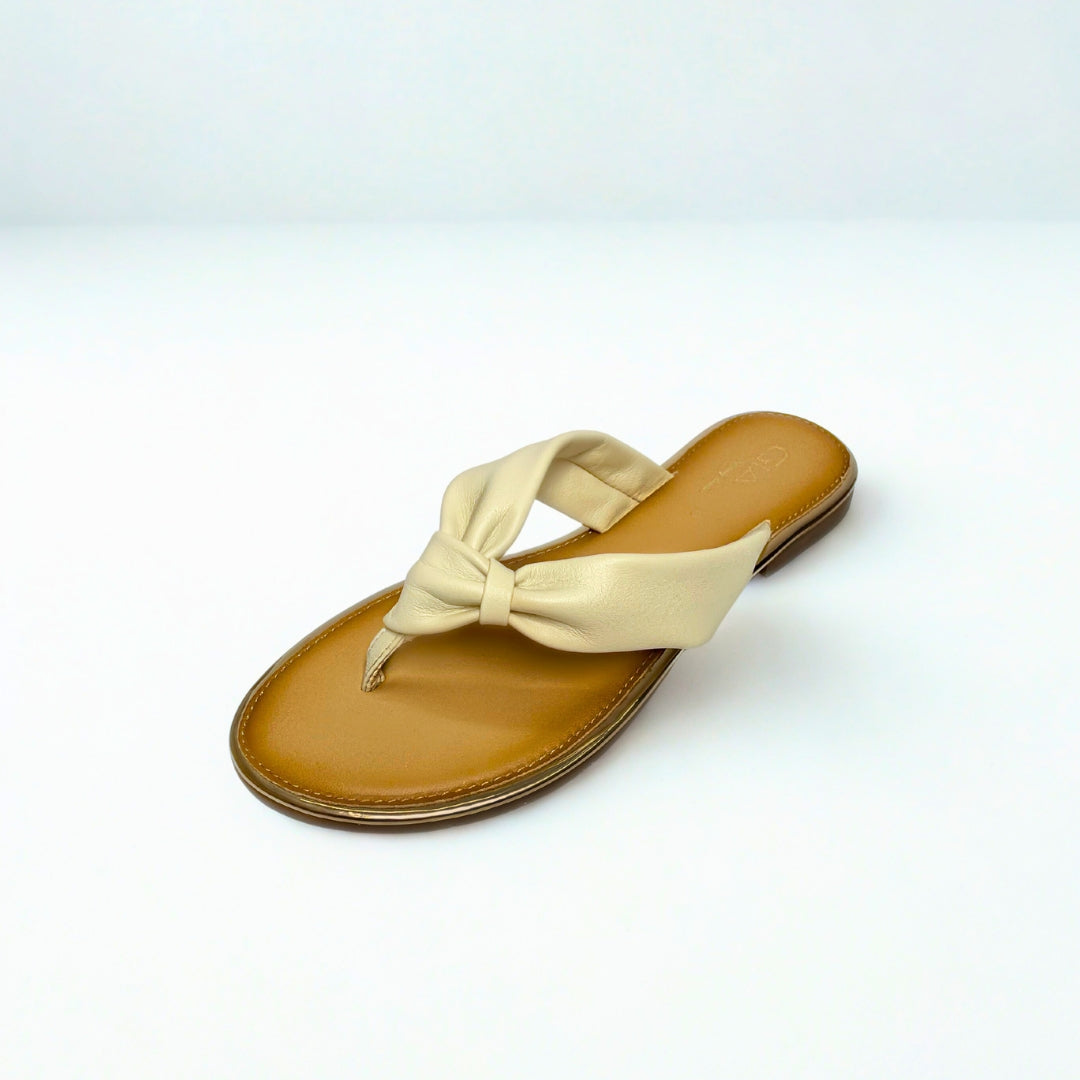 Gia beige leather knot sandals with cushioned insole, slip-on design, and knotted strap detail – chic women’s summer footwear for casual wear, holidays, and resort style. 