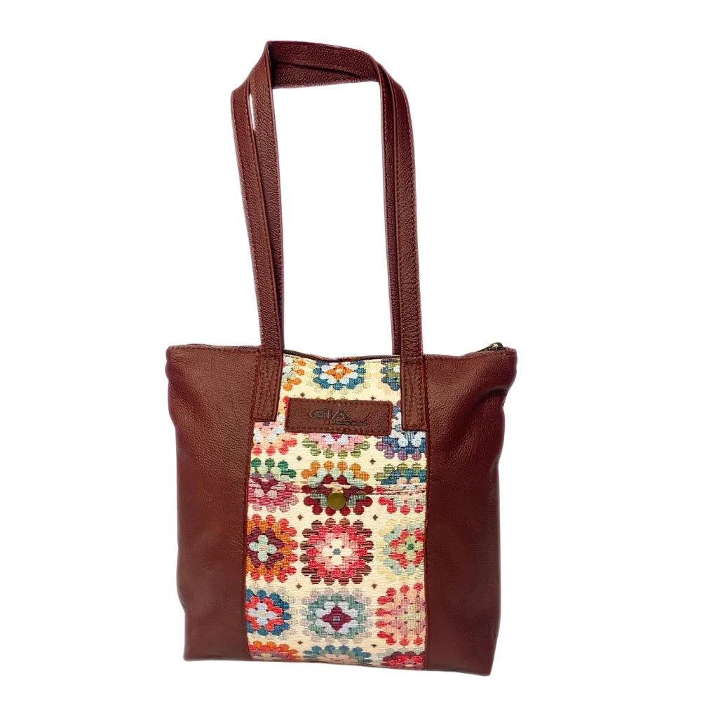 Gia dark red leather tote bag with woven tapestry panel, dual shoulder straps, antique brass hardware, and embossed logo – spacious crochet-inspired handbag for work, travel, and everyday wear.