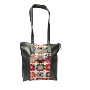 Gia pewter leather tote bag with woven tapestry panel, dual shoulder straps, antique brass hardware, and embossed logo – spacious crochet-inspired handbag for work, travel, and everyday style.