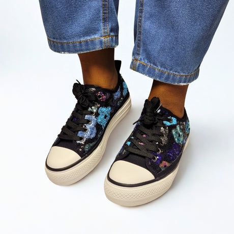 Savoy Black Floral Lace-Up Sneaker – stylish sneaker featuring a sequin floral fabric upper in beige with multicolor floral details. Designed with a thick platform sole for comfort, a classic rubber toe cap for durability, and a secure lace-up closure. Perfect for casual wear and trendy street style. 1