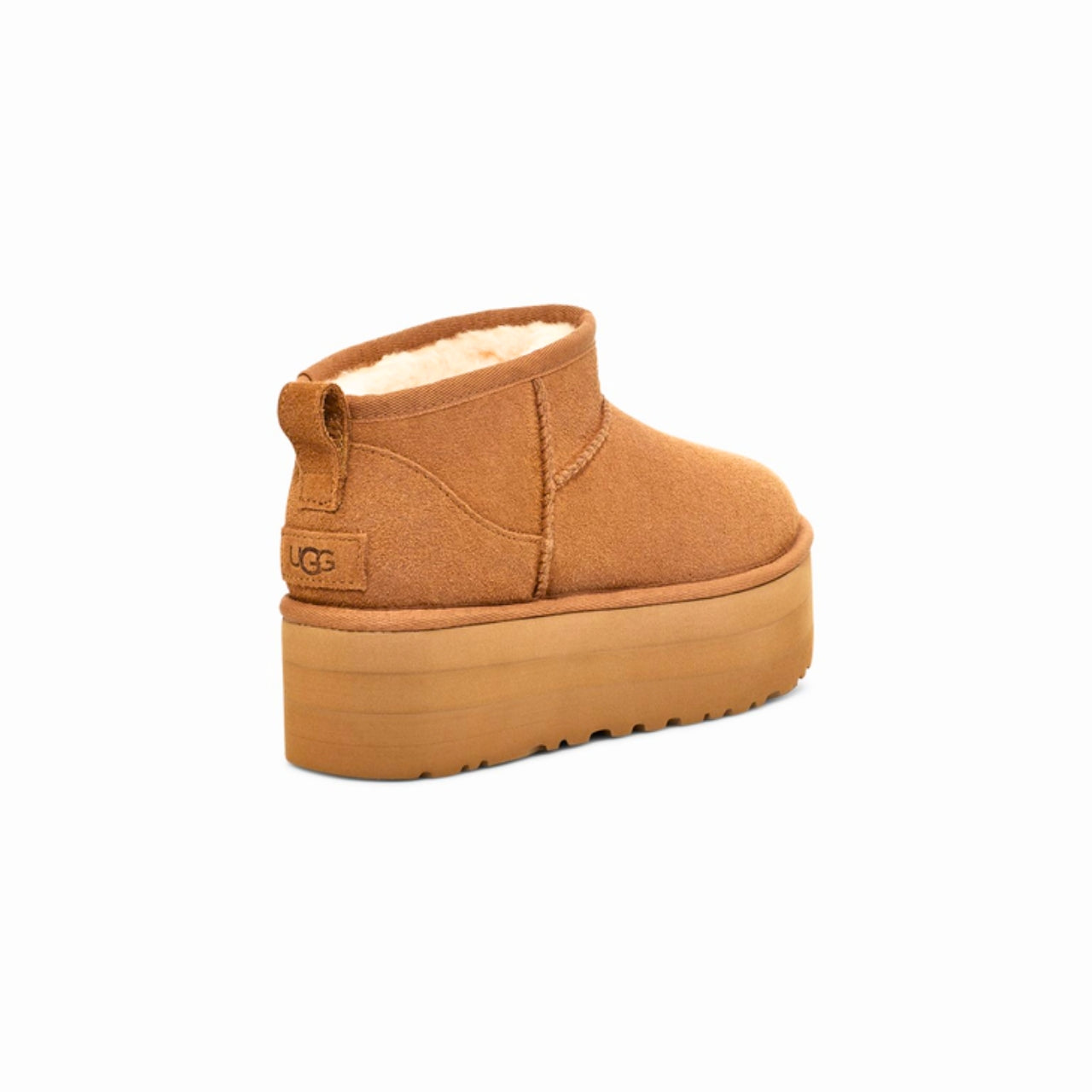 UGG Classic Ultra Mini Platform Boot in Chestnut – A stylish ankle-height boot featuring a suede upper with overlock stitch detailing and a rear pull tab. Designed with a cozy 17mm UGGplush™ lining and insole made from upcycled wool and TENCEL™ Lyocell. Built with a lightweight EVA midsole and a 2" platform Sugarcane EVA or Treadlite outsole for all-day comfort. Finished with an asymmetrical topline, polyester binding, and embossed UGG® logo on the suede heel. Shaft height: 3.5 inches.