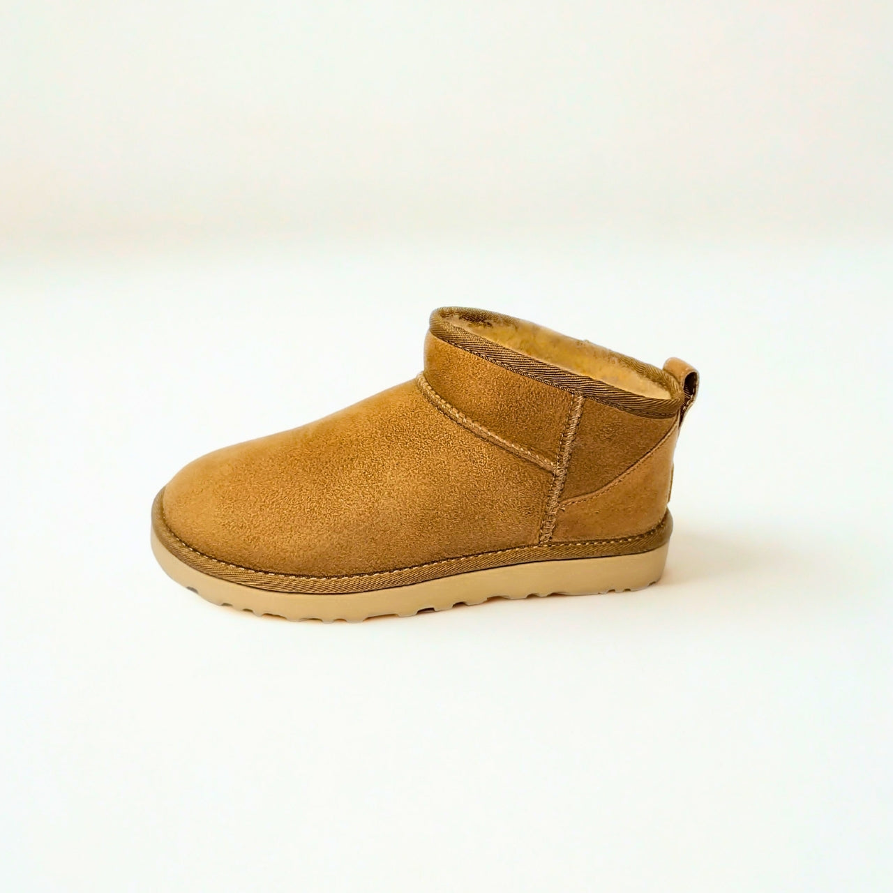  UGG Classic Ultra Mini sand sheepskin boots with 3.5" shaft, water-repellent suede, and sugarcane EVA outsole 3